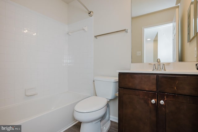 bathroom featuring washtub / shower combination, vanity, and toilet