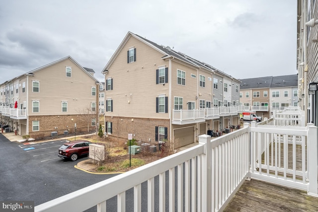 balcony with a residential view and cooling unit