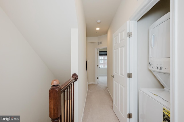 washroom with stacked washer and clothes dryer, recessed lighting, light colored carpet, visible vents, and laundry area