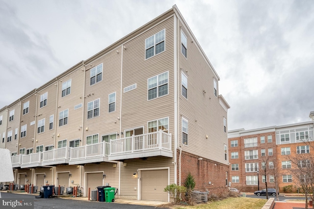 view of property featuring a garage and central AC