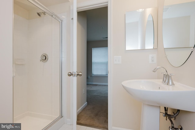 bathroom featuring a stall shower, visible vents, and baseboards