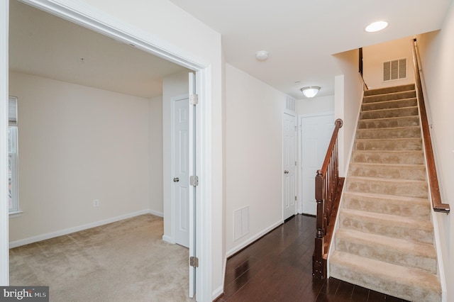 stairs featuring recessed lighting, visible vents, baseboards, and wood finished floors