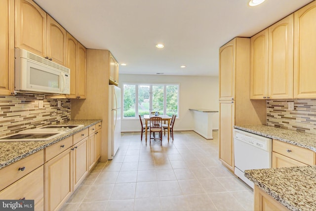 kitchen with light brown cabinets, white appliances, backsplash, light stone countertops, and light tile patterned floors