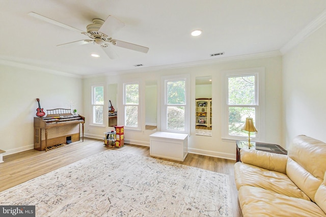 sitting room featuring crown molding, plenty of natural light, ceiling fan, and light hardwood / wood-style floors