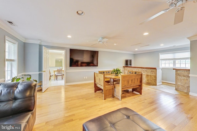 dining space with ceiling fan, light wood-type flooring, and crown molding