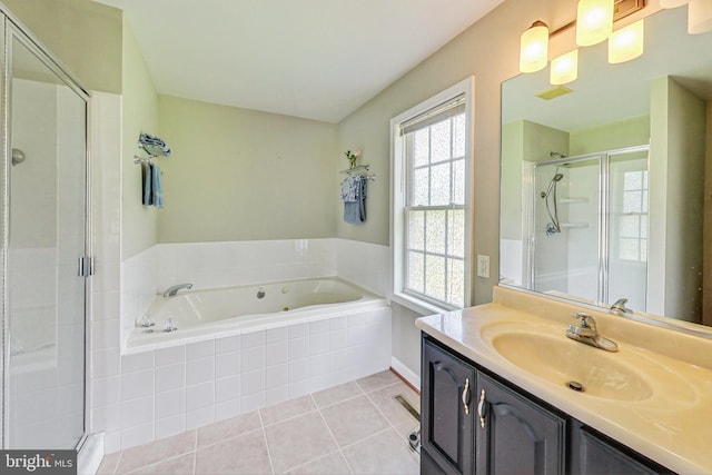 bathroom with tile patterned flooring, vanity, independent shower and bath, and a wealth of natural light