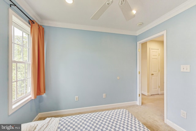 bedroom with ceiling fan, crown molding, and light carpet