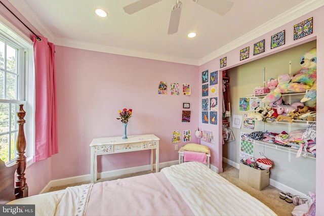 carpeted bedroom with ceiling fan and ornamental molding