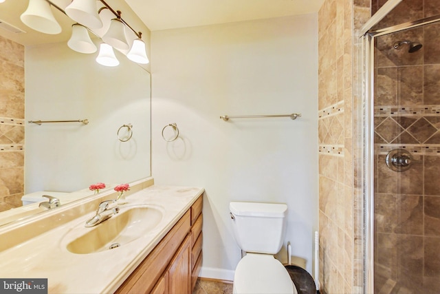 bathroom with toilet, an enclosed shower, and vanity