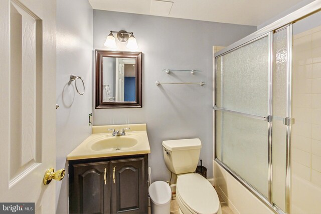 full bathroom with vanity, toilet, and combined bath / shower with glass door