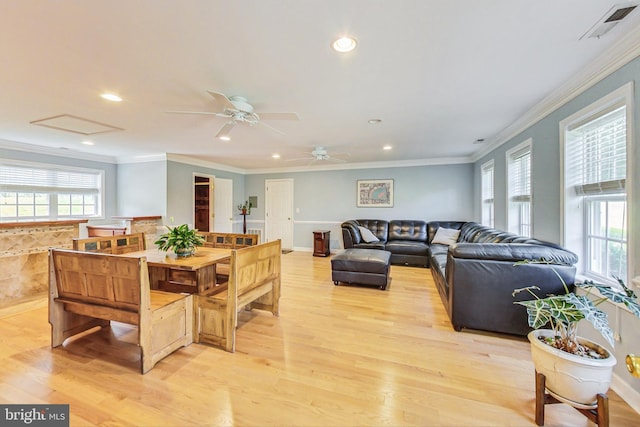 dining room featuring ceiling fan, crown molding, and light hardwood / wood-style flooring