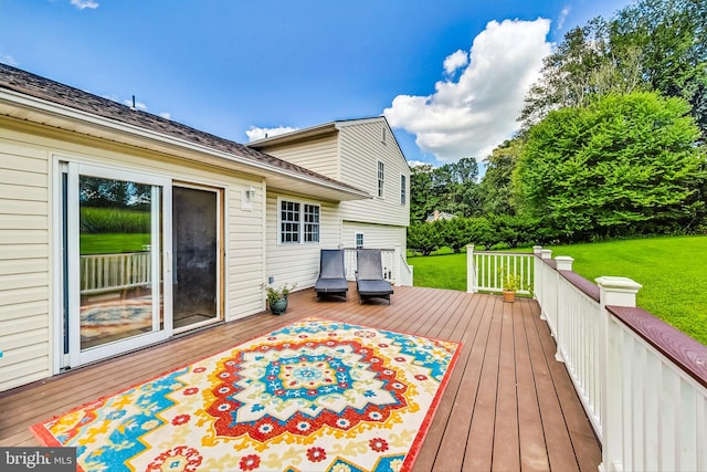 wooden deck featuring a yard