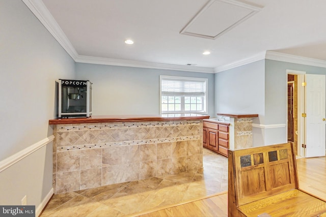 bar with light wood-type flooring and ornamental molding