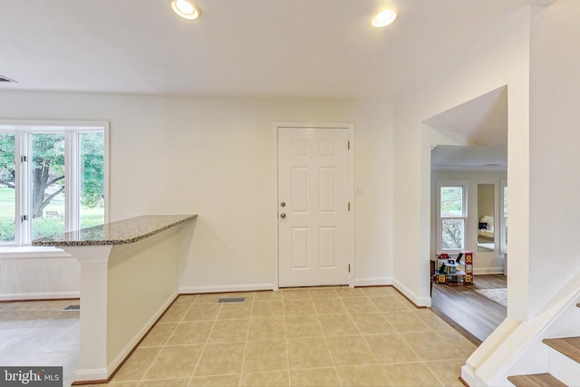 entryway with light hardwood / wood-style floors and a wealth of natural light