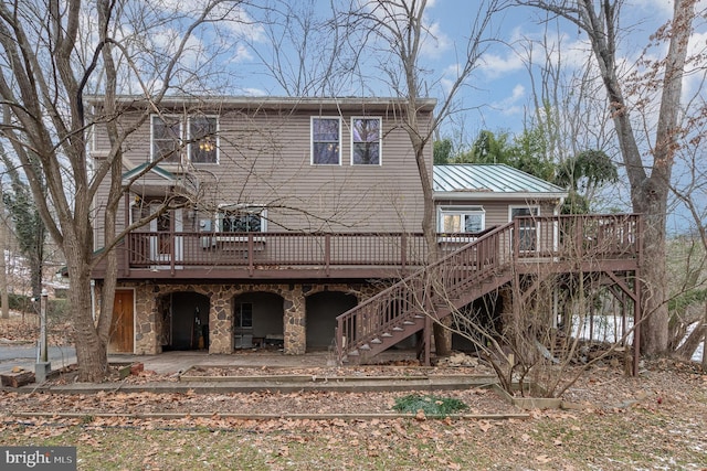 rear view of house with a patio and a wooden deck