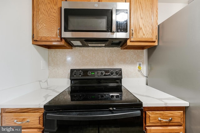 kitchen with tasteful backsplash and appliances with stainless steel finishes
