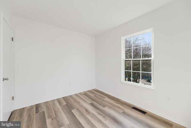 spare room featuring light hardwood / wood-style flooring