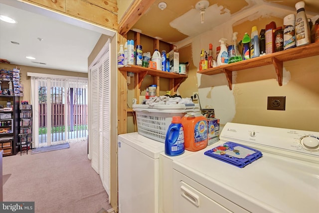 laundry room with washer and clothes dryer and light colored carpet