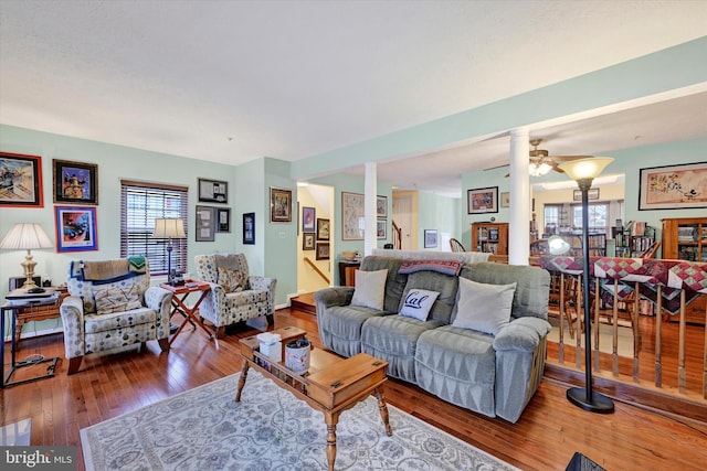 living room featuring hardwood / wood-style floors and ceiling fan