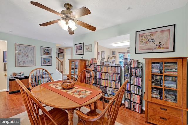 dining area featuring ceiling fan, a textured ceiling, and light wood-type flooring