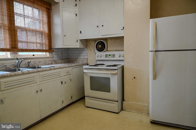 kitchen with white cabinetry, white appliances, sink, and a wealth of natural light