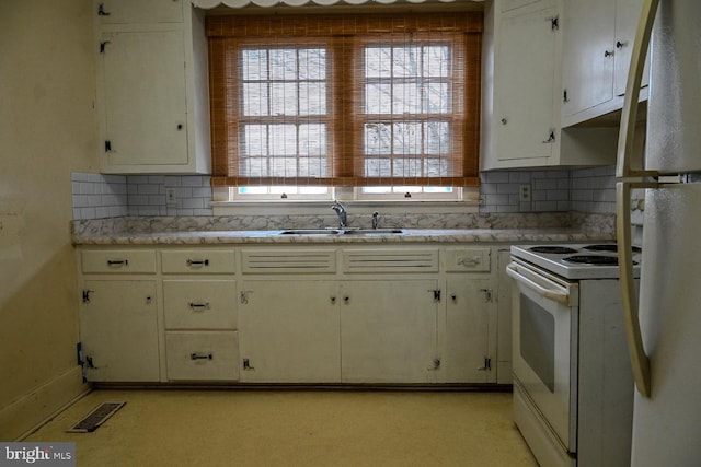 kitchen with white cabinets, white appliances, backsplash, and sink