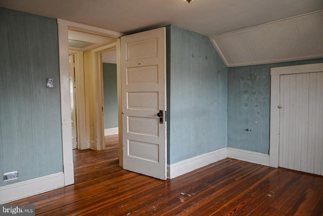 bonus room with dark hardwood / wood-style floors and vaulted ceiling