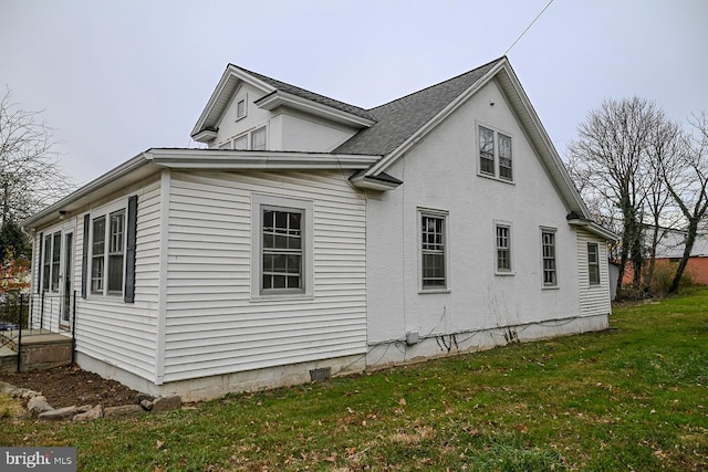 view of side of home featuring a yard