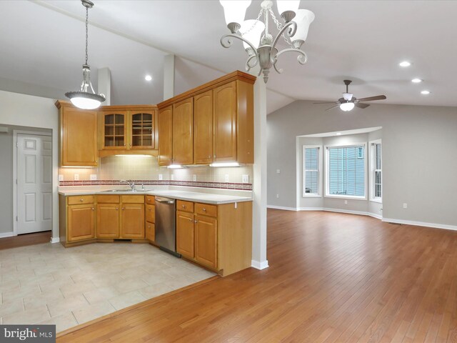 kitchen featuring stainless steel dishwasher, ceiling fan with notable chandelier, sink, light hardwood / wood-style flooring, and lofted ceiling