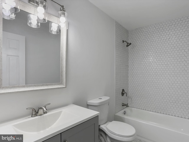 full bathroom featuring vanity, toilet, and tiled shower / bath