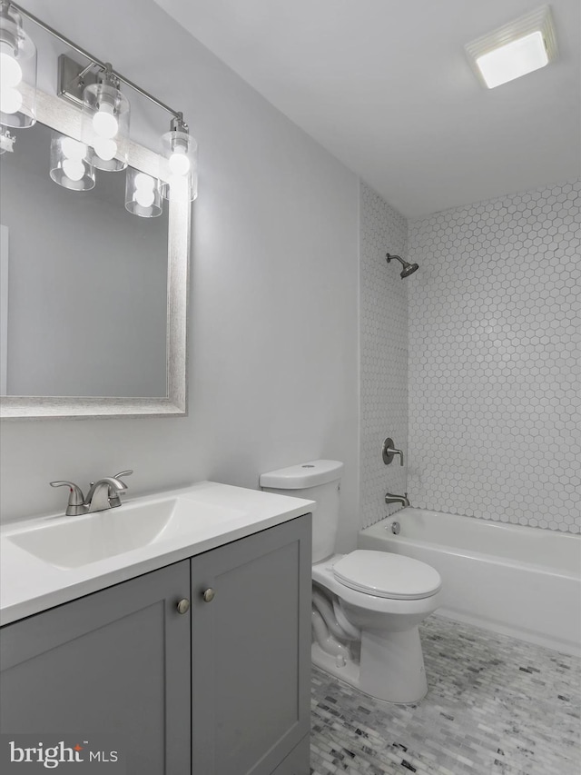 full bathroom featuring vanity, toilet, and tiled shower / bath