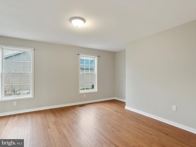 empty room with light hardwood / wood-style floors