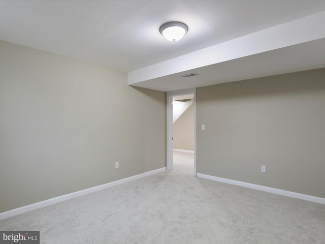 basement featuring light colored carpet