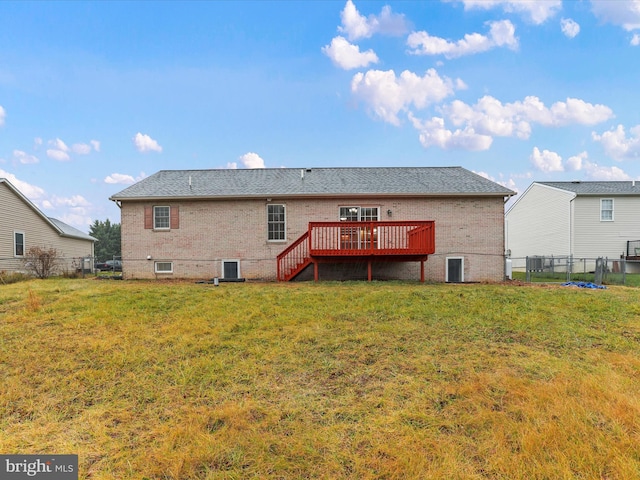 rear view of house with a lawn and a deck