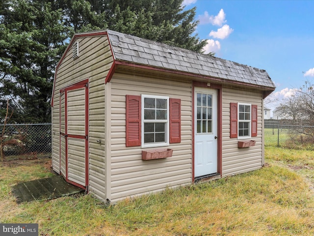 view of outbuilding with a yard