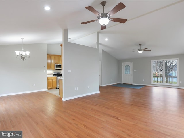 unfurnished living room with ceiling fan with notable chandelier, light hardwood / wood-style flooring, and lofted ceiling