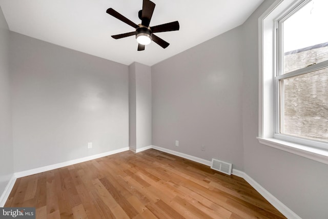 unfurnished room featuring ceiling fan, a healthy amount of sunlight, light hardwood / wood-style floors, and lofted ceiling