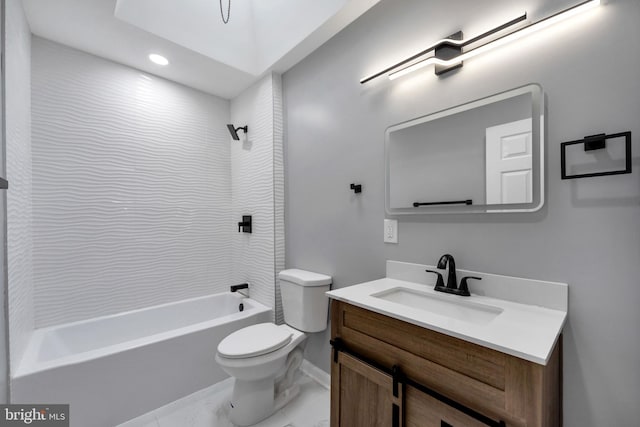 full bathroom with tiled shower / bath, vanity, and toilet