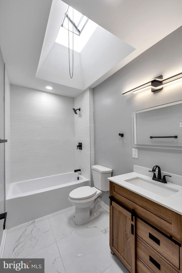 full bathroom featuring a skylight, toilet, vanity, and tiled shower / bath