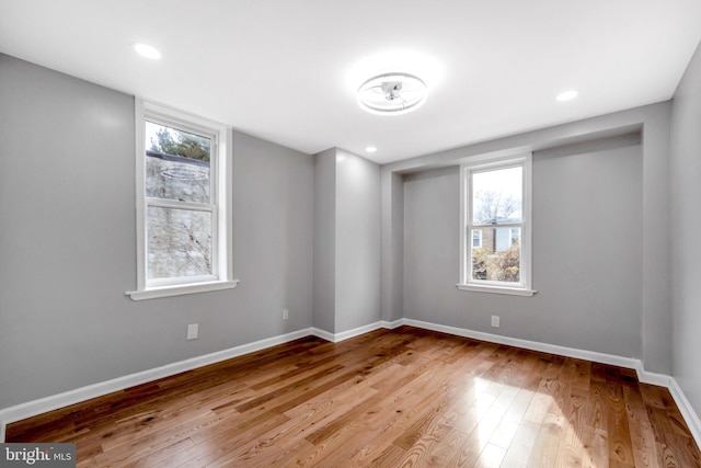 unfurnished room featuring a wealth of natural light and light hardwood / wood-style flooring