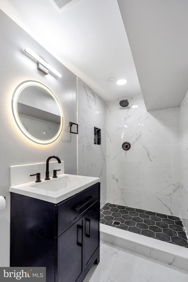 bathroom featuring vanity and a tile shower