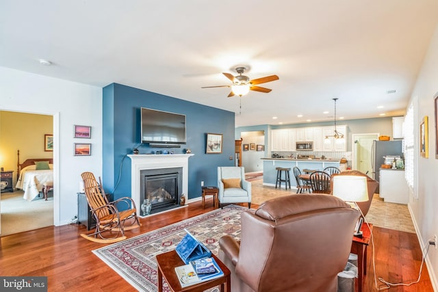 living room featuring hardwood / wood-style floors and ceiling fan