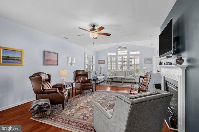 living room featuring hardwood / wood-style floors, ceiling fan, and lofted ceiling