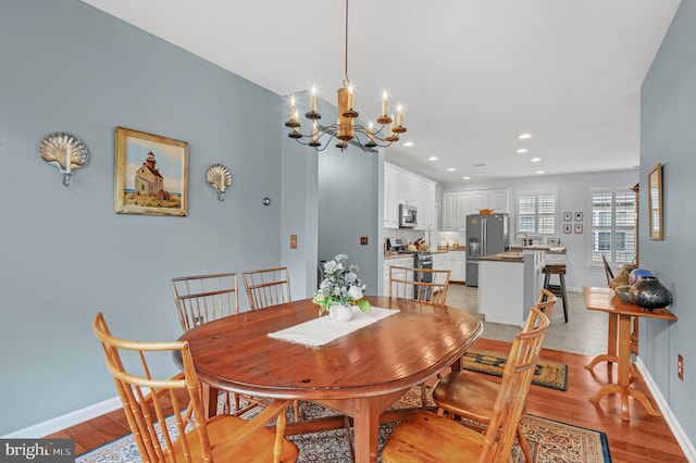 dining room featuring light hardwood / wood-style floors and an inviting chandelier