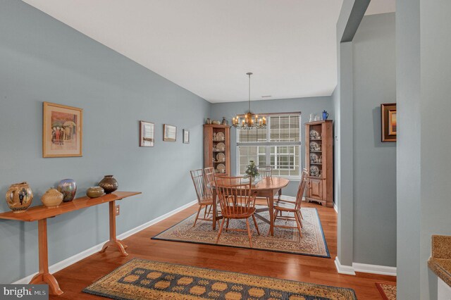 dining room with a chandelier and hardwood / wood-style floors