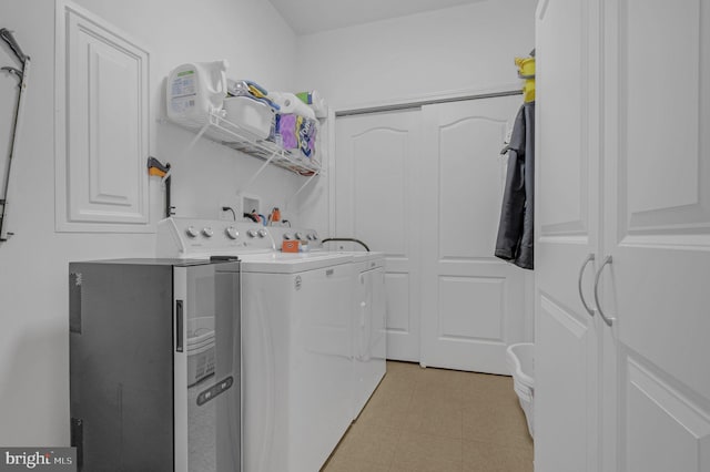 clothes washing area featuring separate washer and dryer