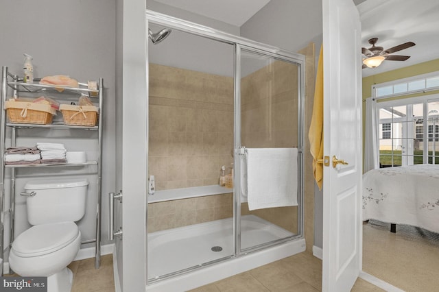 bathroom with tile patterned flooring, toilet, ceiling fan, and a shower with shower door