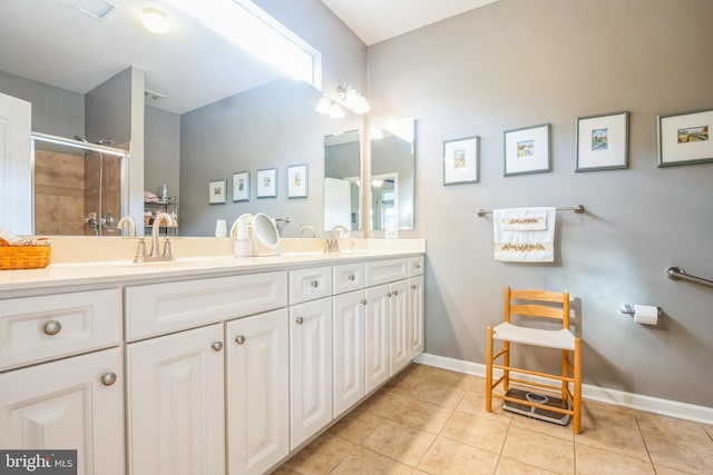 bathroom featuring vanity, tile patterned floors, and walk in shower