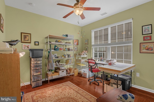 home office with ceiling fan and dark hardwood / wood-style flooring