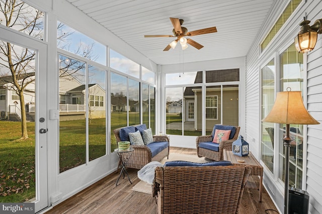 sunroom / solarium featuring ceiling fan